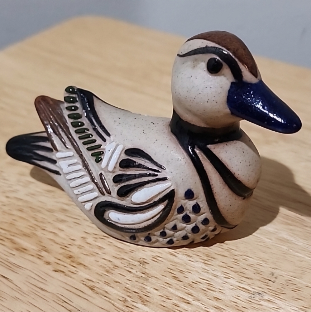 Ceramic Pottery Duck sand colored with blue, white, and brown paint accents